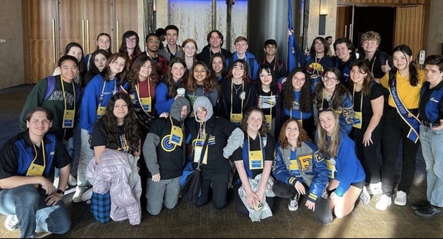 Bailey Crawford(to the right, in yellow) and other FHS students at Texas Thespian Festival 2022