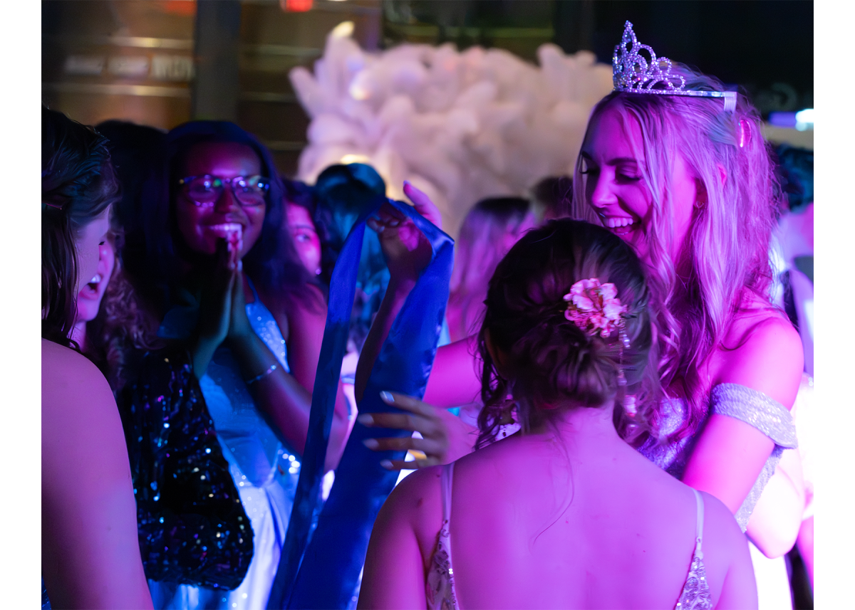 Senior Finley Johnson celebrates her Prom Queen title with her friends. It was really awesome to know that my peers elected me to put in that position, Johnson said. I felt really supportive and it was a really sweet moment to experience around all of my friends.