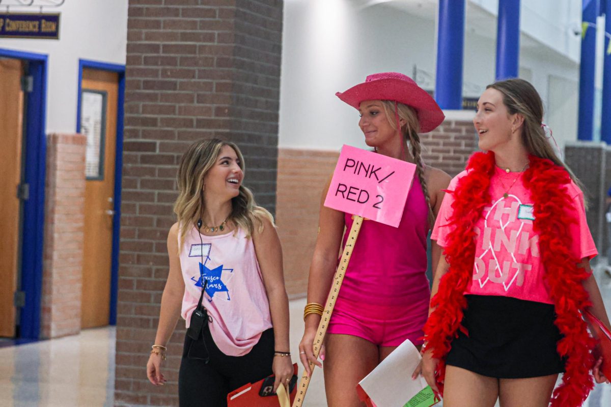 Members of the Stars dance team walk together during Raccoon rally on  Aug. 6. 